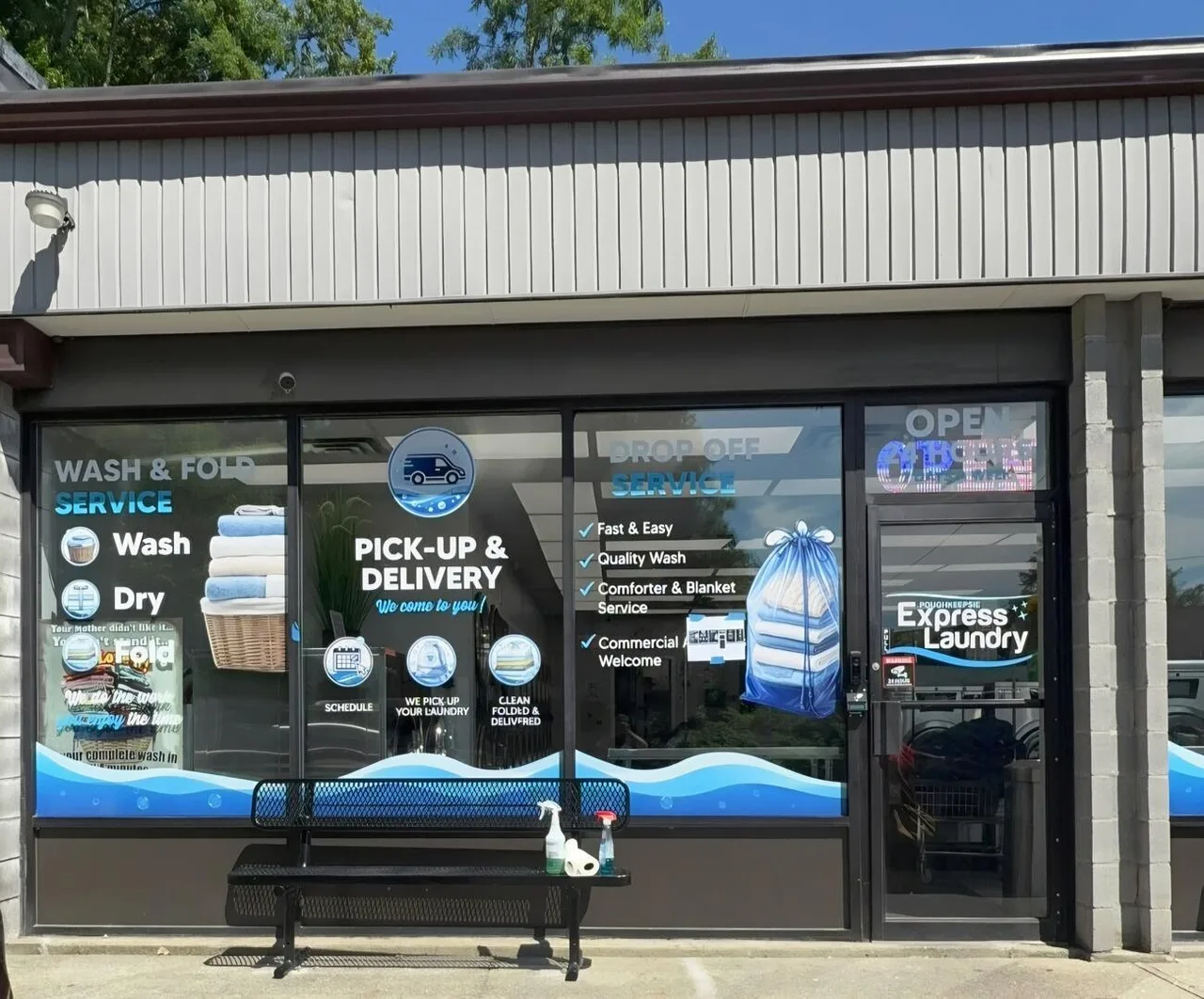 Storefront windows with wash and fold and pickup and delivery signage