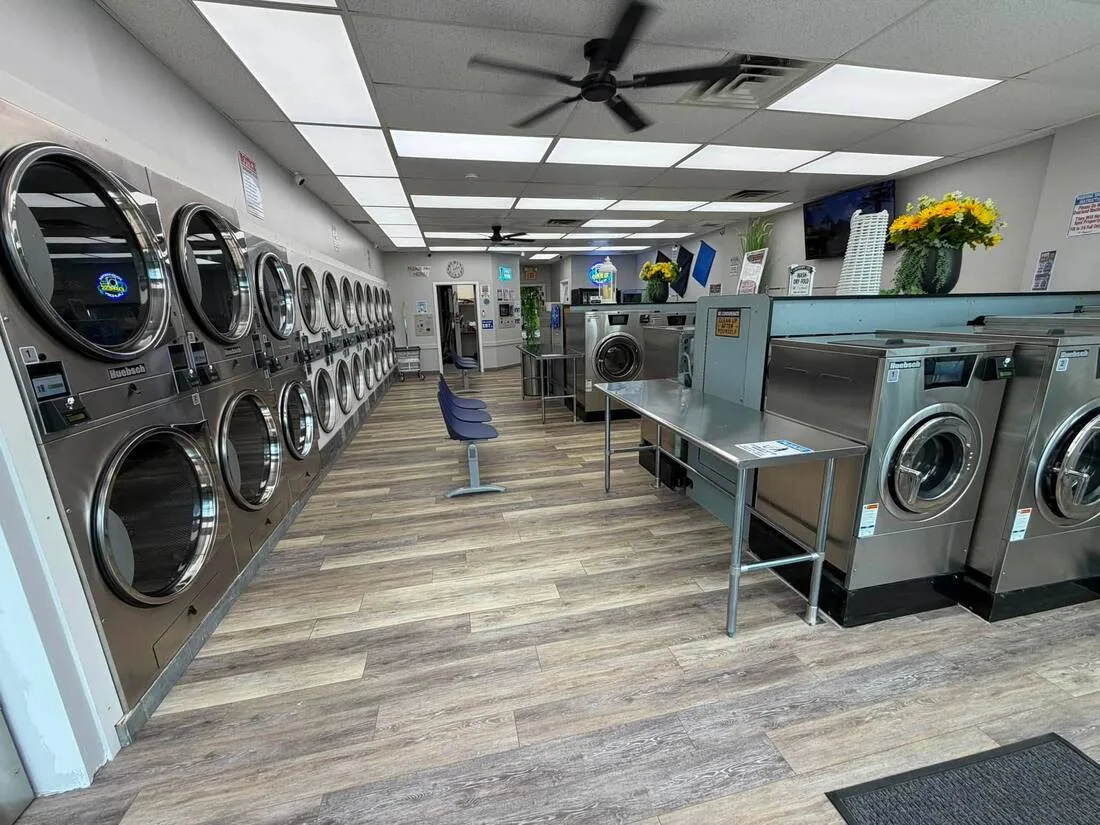 Bright renovated Poughkeepsie laundromat with folding tables and modern washers